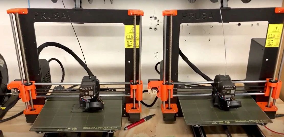 Two Original Prusa i3 MK3 3D printers running simultaneously to fabricate the necklace pendant housings